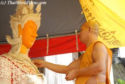 Monk working with wax